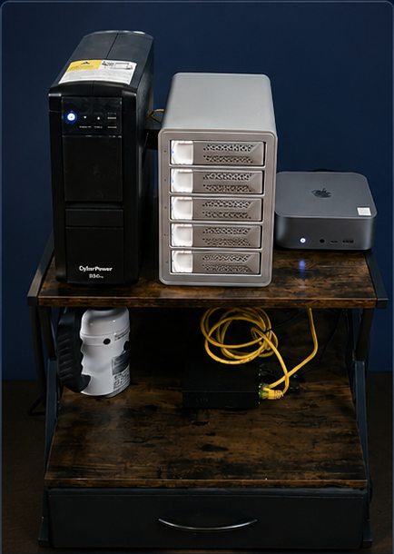 Dragon's Vault home server: tower PC, DAS drive enclosure, and Mac mini on a wooden stand
