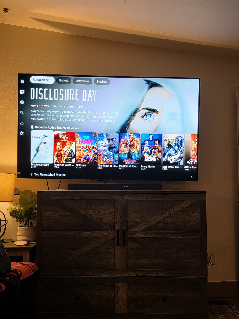 Plezy New Releases row on a wall-mounted TV