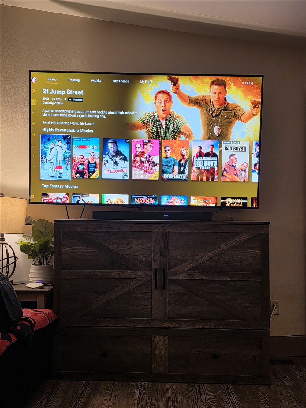 Plex Highly Rewatchable Movies row on a wall-mounted TV