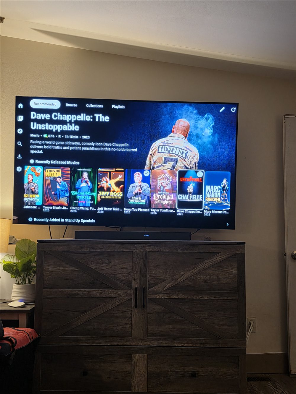 Plezy Standup Comedy row on a wall-mounted TV
